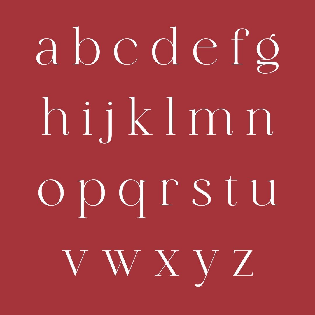 Elegant white serif alphabet from a to z displayed on a deep red background, showcasing classic serif typeface design with refined letterforms